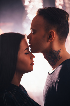 guy and the girl kiss closeup on a light backgroundの写真素材