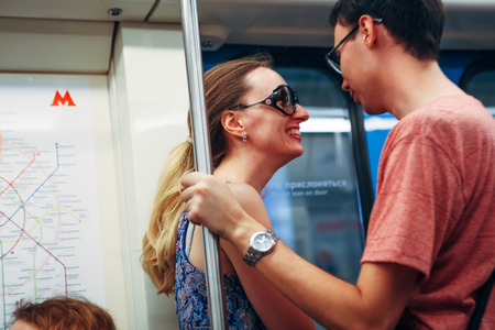 girl and guy stand in the subway.の写真素材
