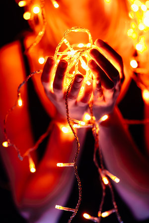 portrait of a girl with a garland on black background.の写真素材
