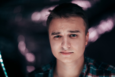 portrait of a young man on a blurred background.の写真素材