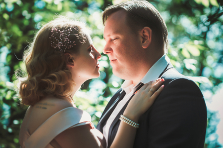 bride and groom on the background of trees and forest sun.の写真素材