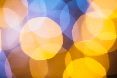 large gold and silver bokeh on a dark background.の写真素材