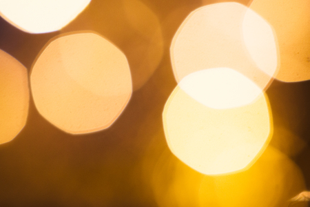 large gold and silver bokeh on a dark background.の写真素材