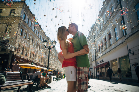 girl and guy on the background of the alley of garlands.の写真素材