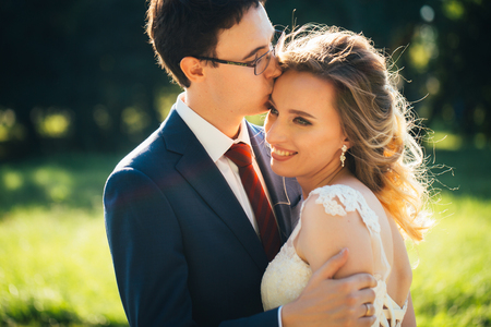 bride and groom embracing on nature background.の写真素材