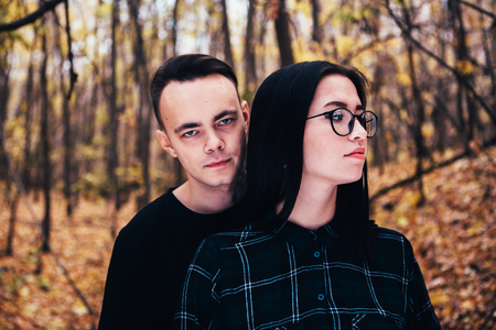 man and woman in the autumn forestの写真素材