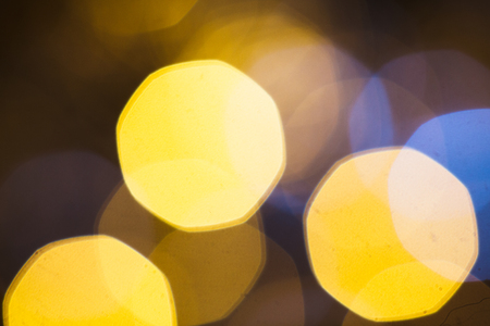 large gold and silver bokeh on a dark background.の写真素材
