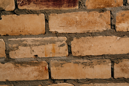 dark orange beige brick with cement close-up.の写真素材