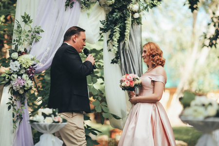 bride and groom on wedding ceremony on background nature.の写真素材