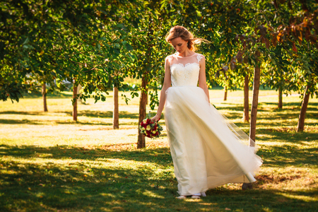 happy young bride on autumn forest background.の写真素材