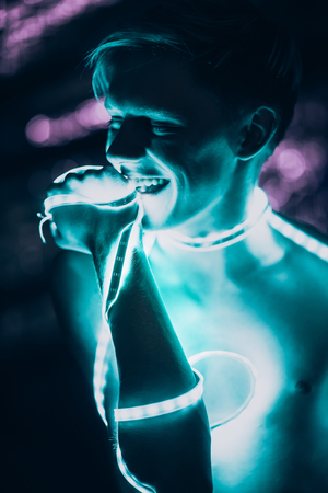 Portrait man Strip Light LED tape on dark color background.の写真素材