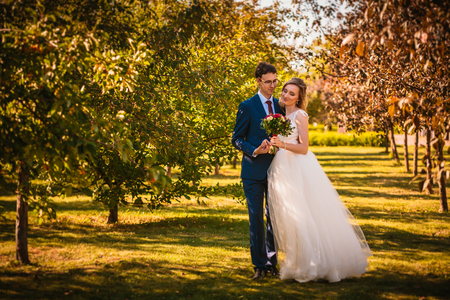 Beautiful stylish bride and groom on garden background.の写真素材