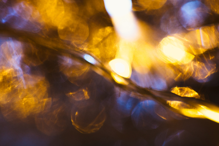 gold and silver bokeh on a dark background.の写真素材