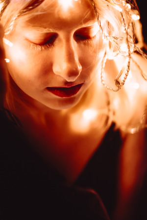 portrait of a girl with a garland on black background.の写真素材