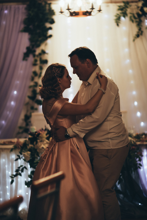 bride and groom first dancing on background a restaurant.の写真素材