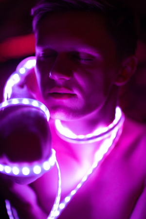 Portrait man Strip Light LED tape on dark color background.の写真素材