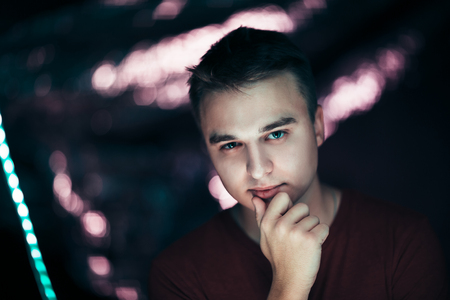 portrait of a young man on a blurred background.の写真素材