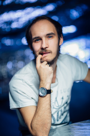 portrait of a guy in a hat on a blurred background.の写真素材