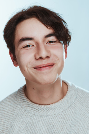portrait of a teenager brunette guy in a studio.の写真素材