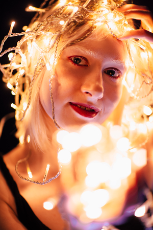 portrait of a girl with a garland on black background.の写真素材