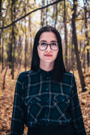 portrait of a young woman in the autumn forest.の写真素材