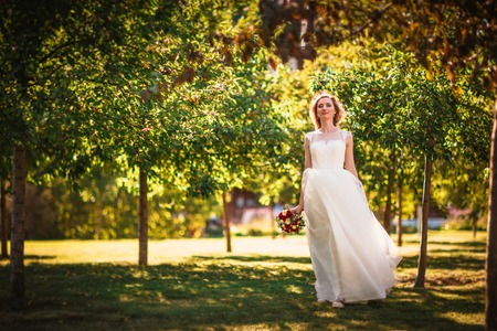 happy young bride on autumn forest background.の写真素材