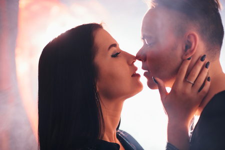 guy and the girl kiss closeup on a light backgroundの写真素材