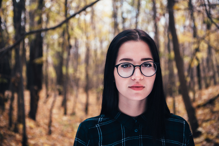 portrait of a young woman in the autumn forest.の写真素材