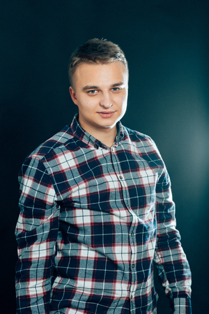 portrait of a young man on a dark background.の写真素材