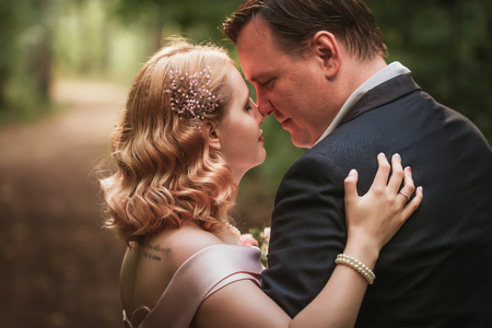 bride and groom dancing in the forest background and sunlight.の写真素材