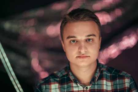 portrait of a young man on a blurred background.の写真素材