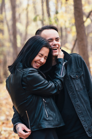 portrait of a young woman and a man walking in the autumn forest.の写真素材