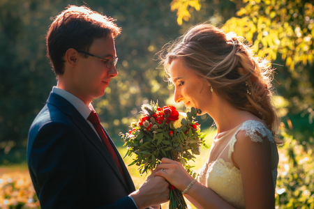 bride and groom on background summer forest.の写真素材