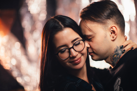 Couple in fashionable clothes on a shiny background.の写真素材