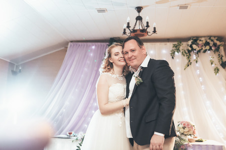 bride and groom first dancing on background a restaurant.の写真素材