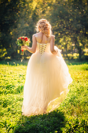 beautiful young bride in the garden background.の写真素材