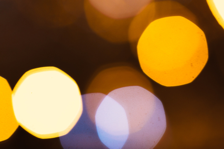 large gold and silver bokeh on a dark background.の写真素材