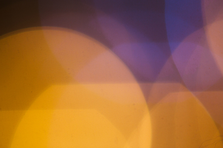 large gold and silver bokeh on a dark background.の写真素材