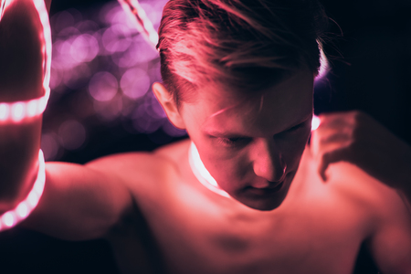 Portrait man Strip Light LED tape on dark color background.の写真素材