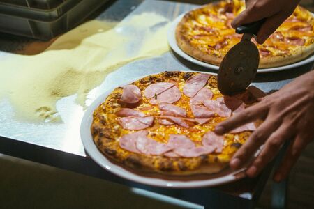 freshly baked pizza cut into several pieces.の写真素材