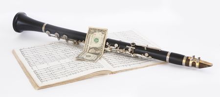 Picture of musical instrument of clarinet and dollar on a white backgroundの写真素材