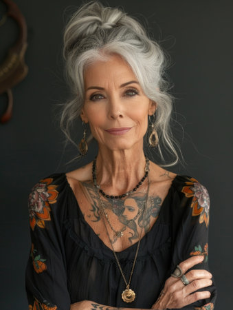 Aging with ink: elderly woman proudly poses with tattoo, showing timeless style and individuality, challenging stereotypes and embracing personal expression through body art.の素材