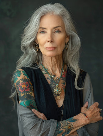Aging with ink: elderly woman proudly poses with tattoo, showing timeless style and individuality, challenging stereotypes and embracing personal expression through body art.の素材