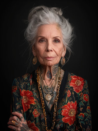 Aging with ink: elderly woman proudly poses with tattoo, showing timeless style and individuality, challenging stereotypes and embracing personal expression through body art.の素材