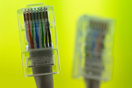 Two old and dusty plugs on the green backgroundの写真素材