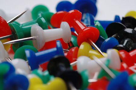 Plastic drawing-pins different colors. Old, dusted and used.