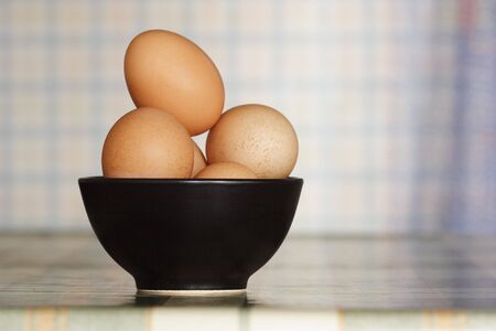 Eggs in black bowl on the table