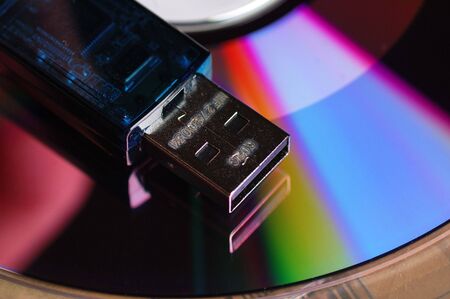 USB flash drive over DVD diskの写真素材