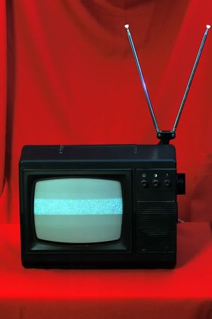Old television set on the red background.の写真素材