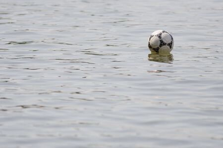 Football ball floating in the water.の写真素材